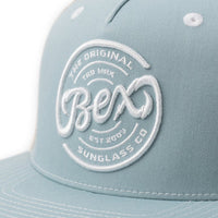 BEX Bolt Flat Bill Trucker Hat in Sky/Tan