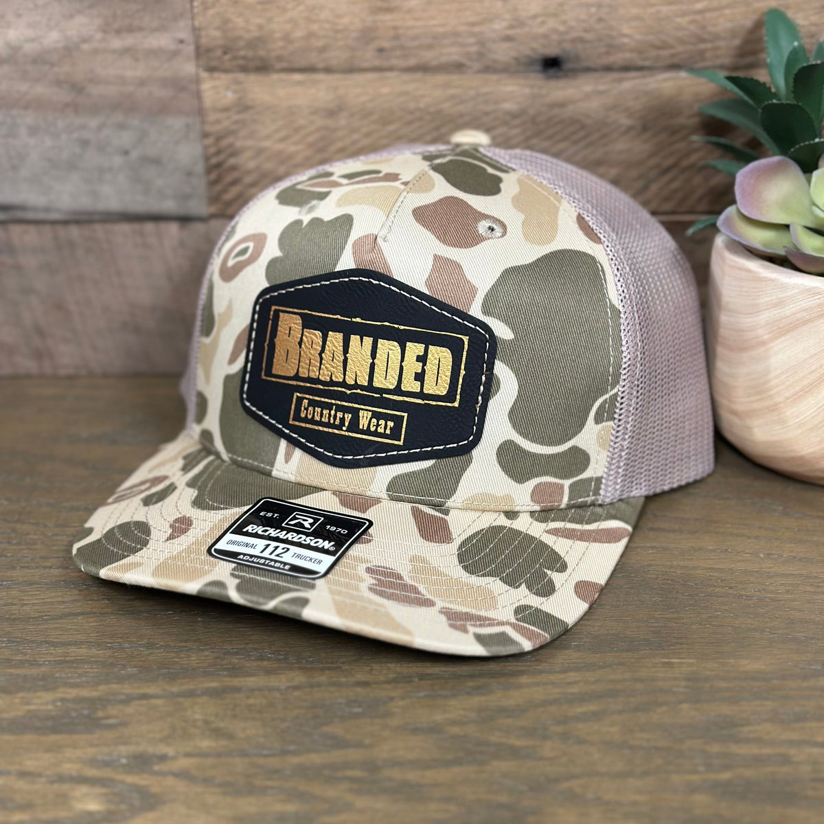 Branded Country Wear Leather Logo Patch Trucker Hat in Harvest Duck Camo